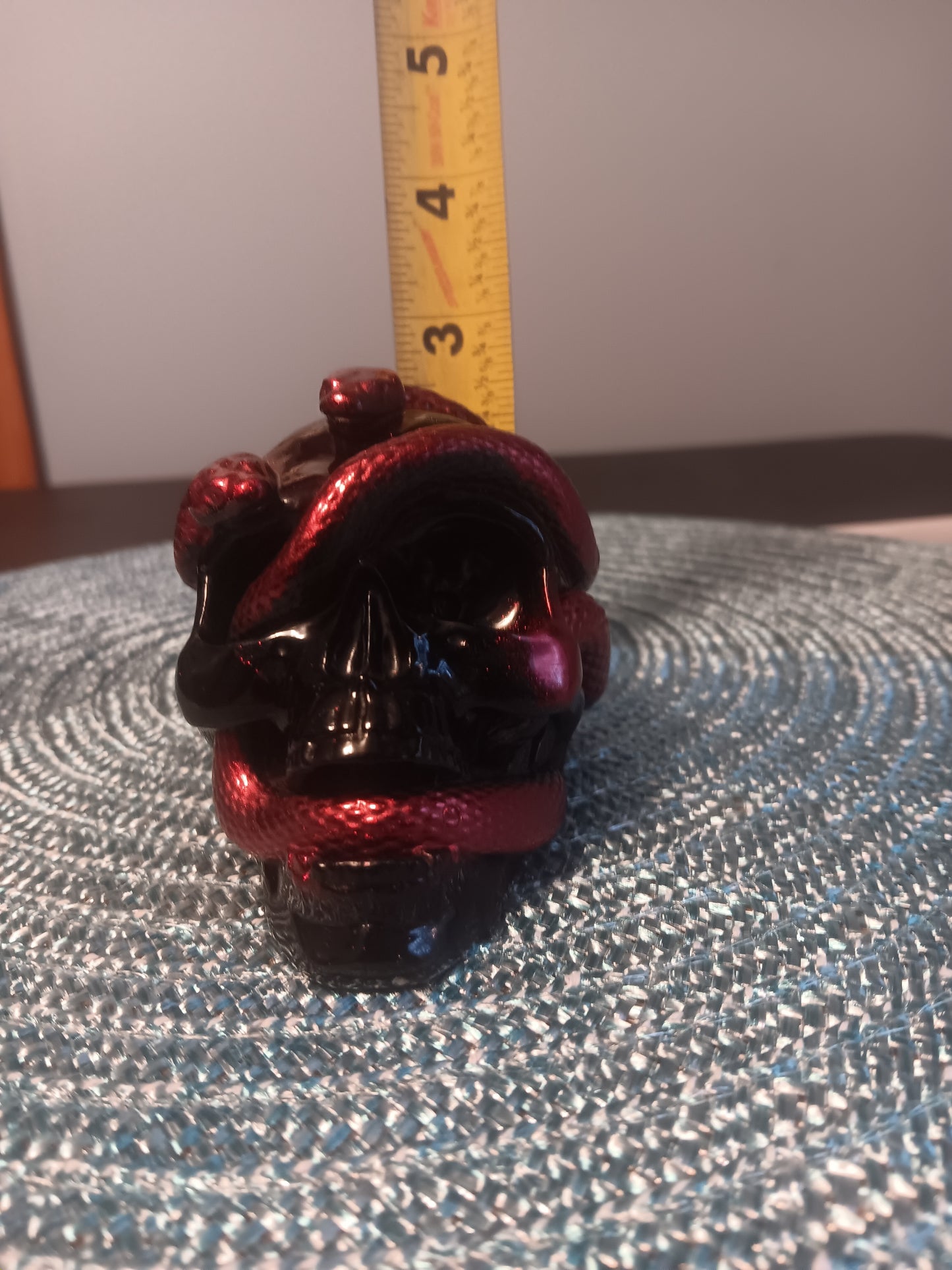 Small Black Skull intertwined with Red Snakes