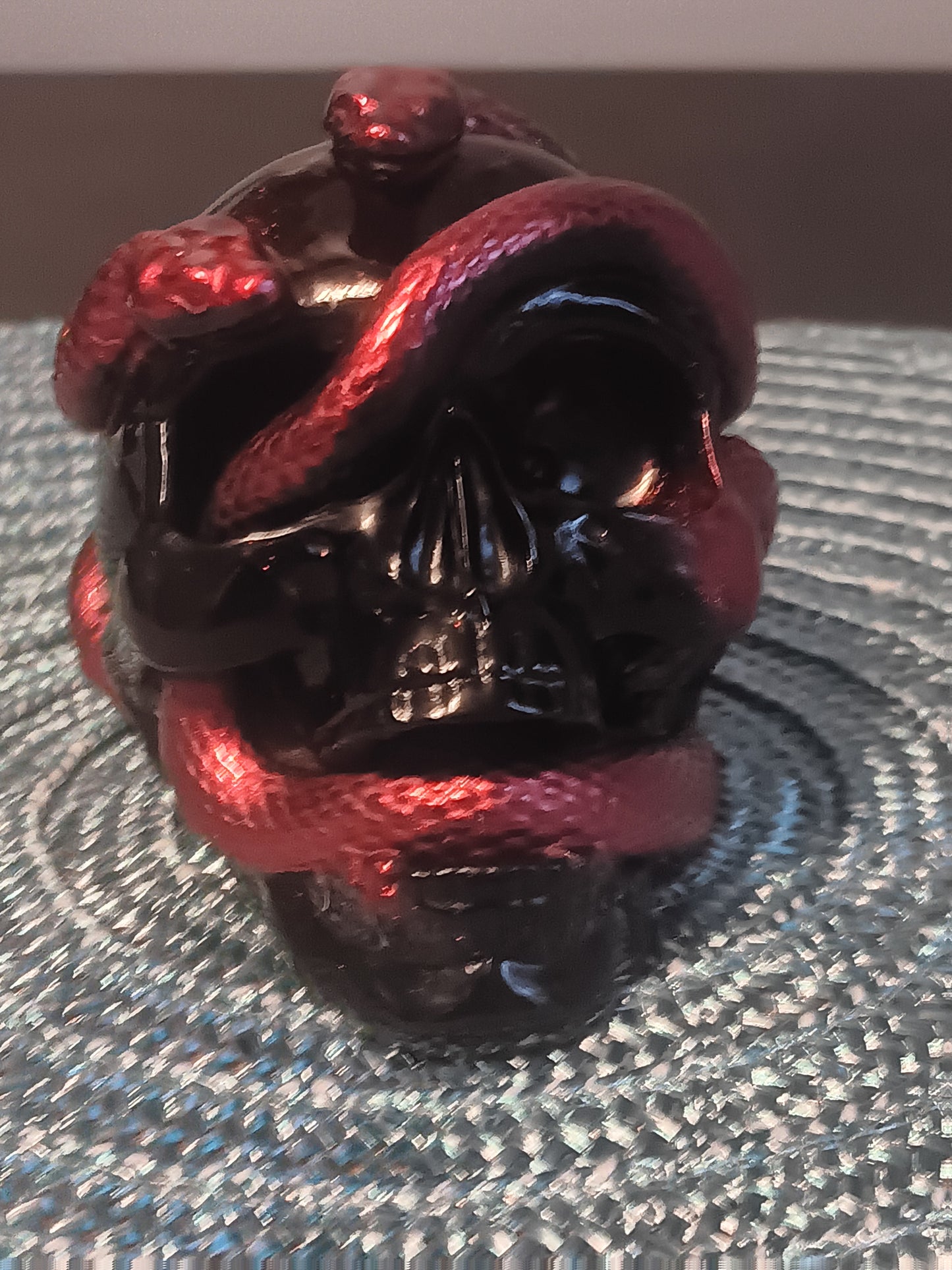 Small Black Skull intertwined with Red Snakes
