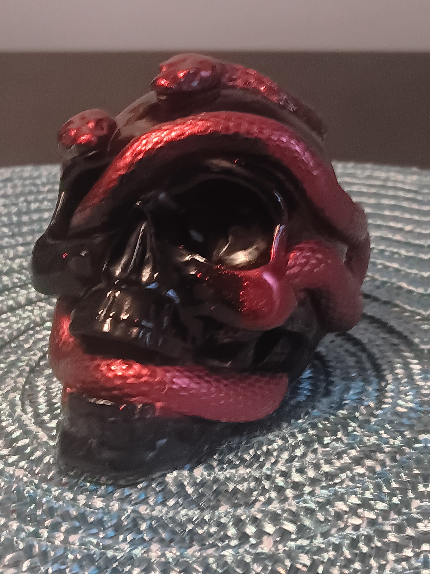 Small Black Skull intertwined with Red Snakes