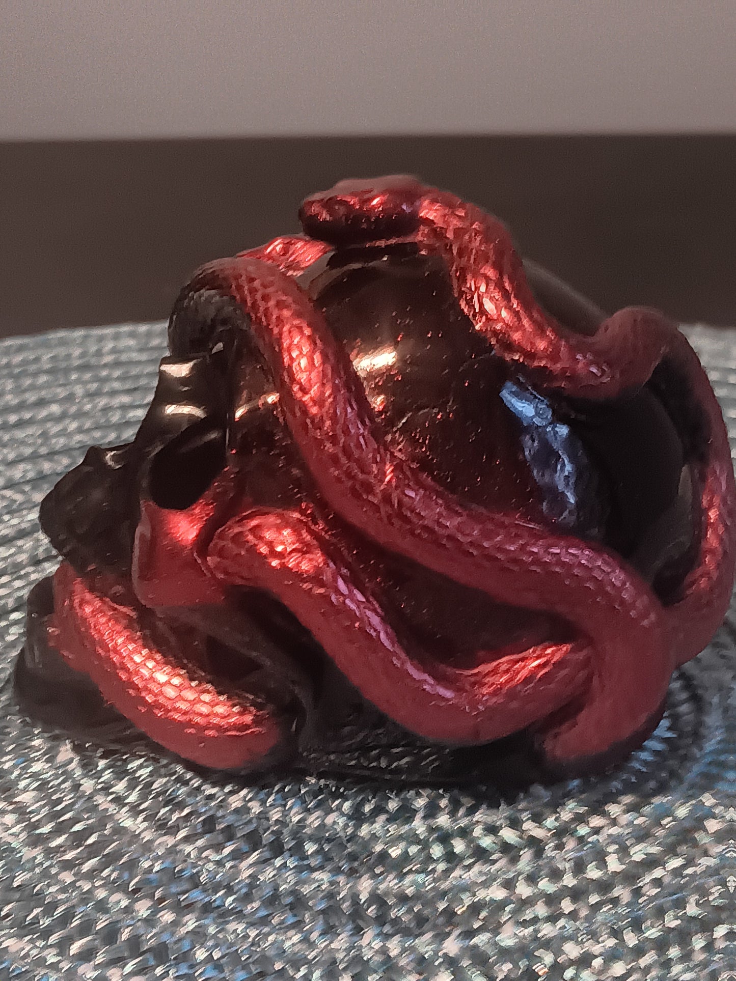 Small Black Skull intertwined with Red Snakes