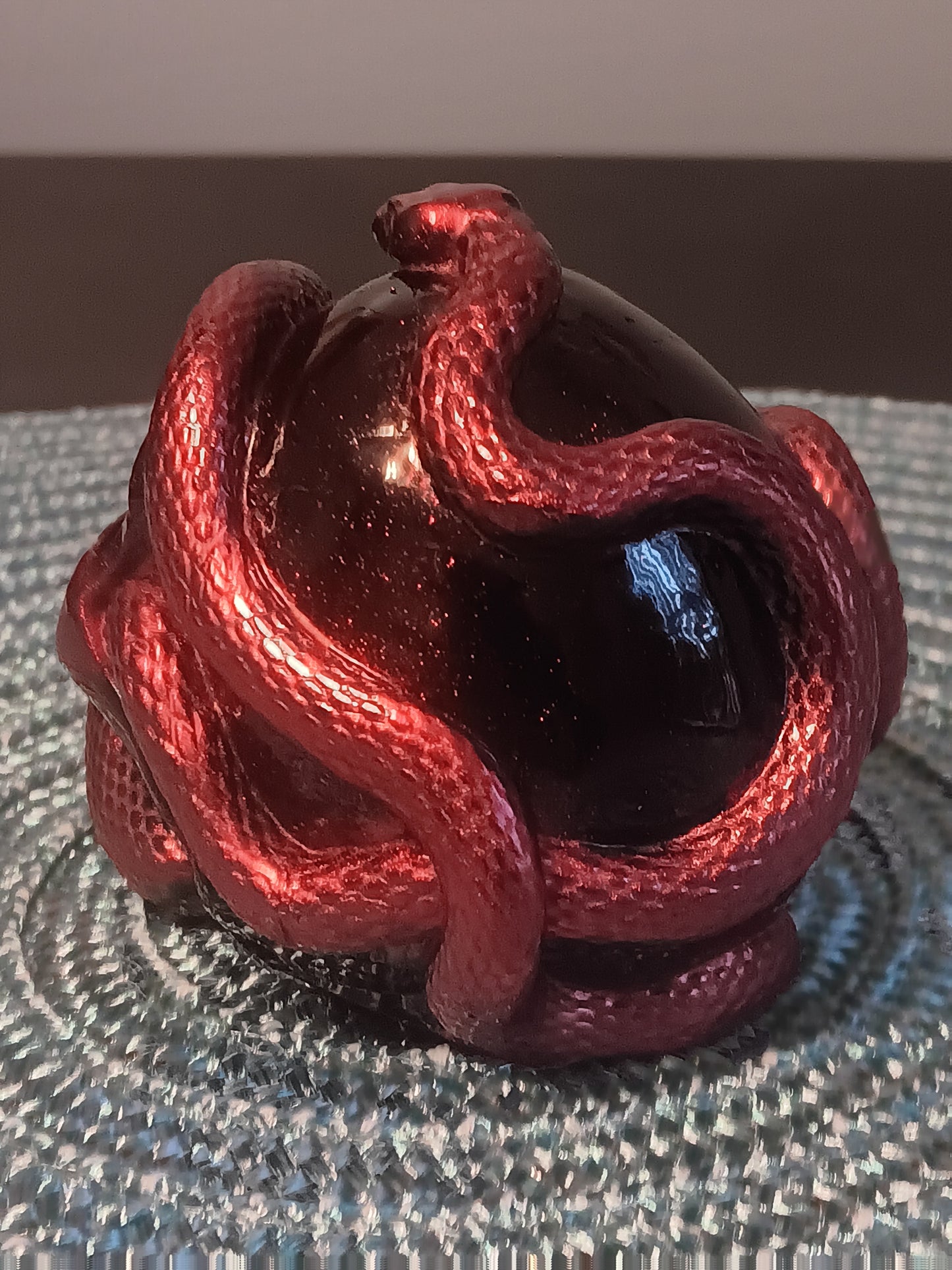 Small Black Skull intertwined with Red Snakes