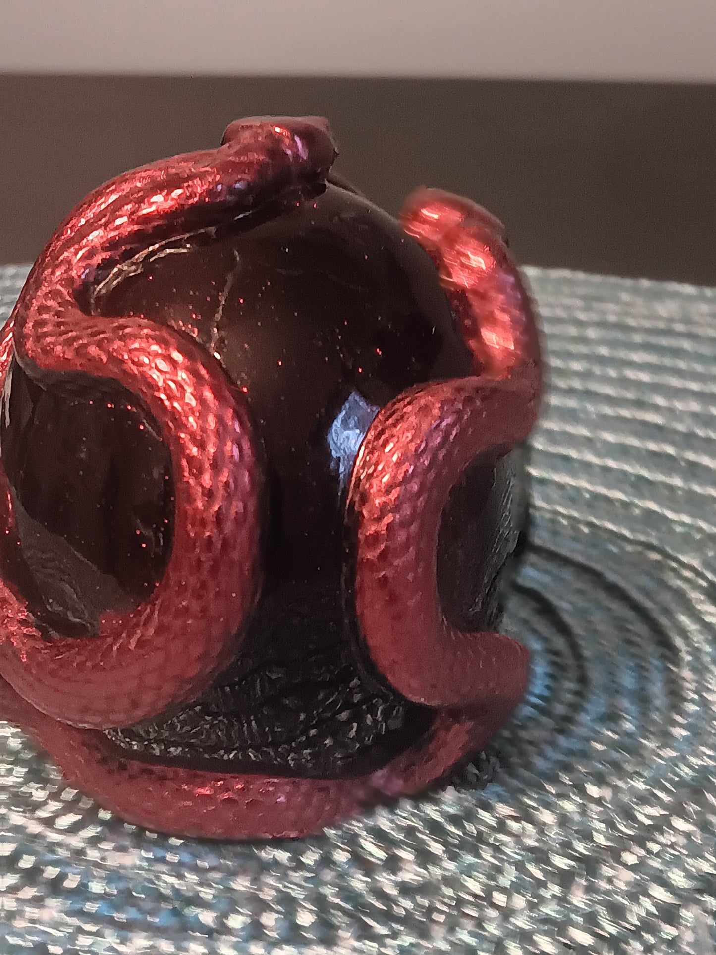 Small Black Skull intertwined with Red Snakes