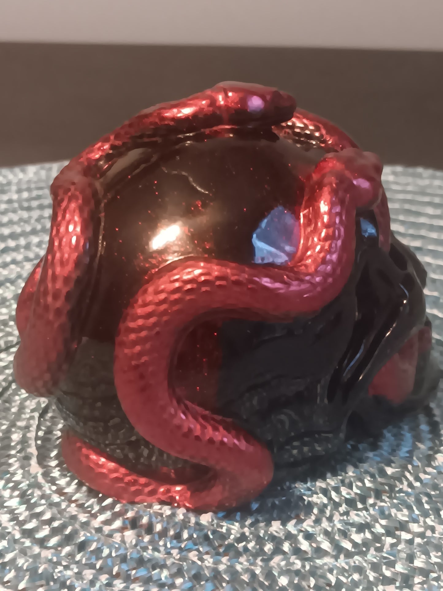 Small Black Skull intertwined with Red Snakes