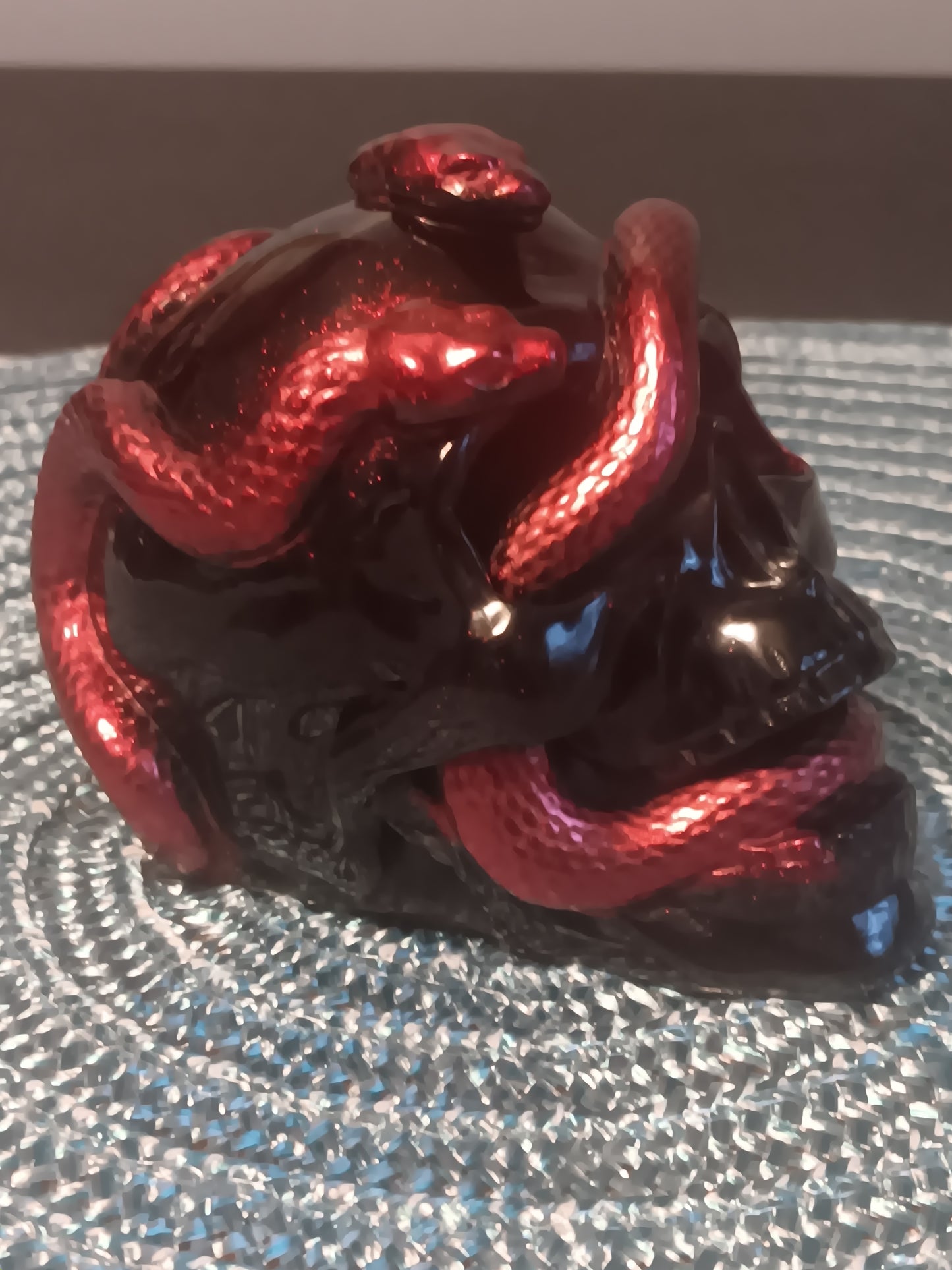 Small Black Skull intertwined with Red Snakes