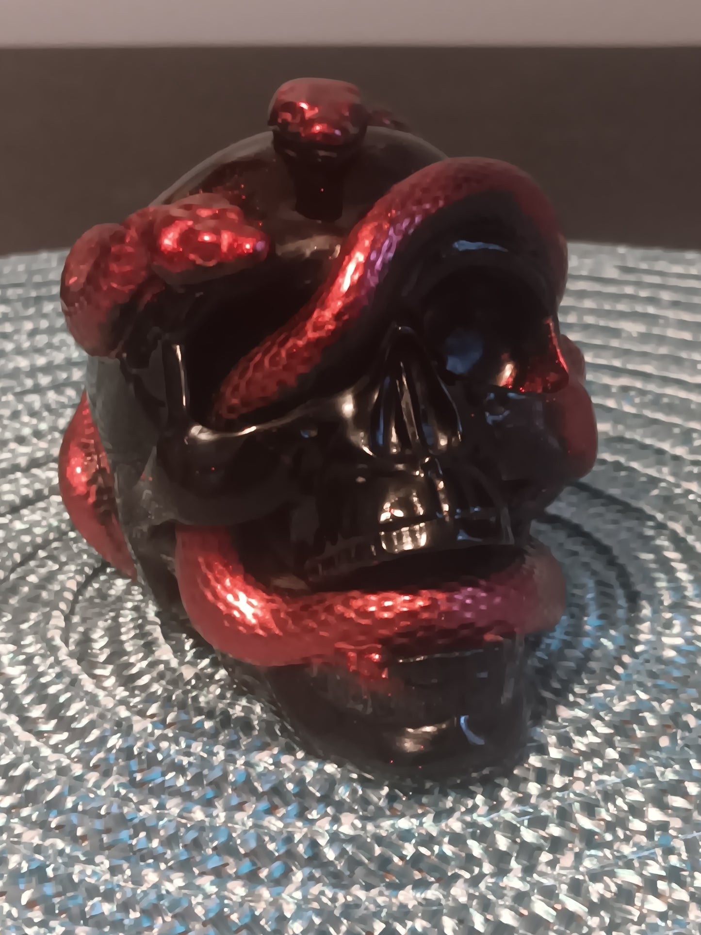 Small Black Skull intertwined with Red Snakes